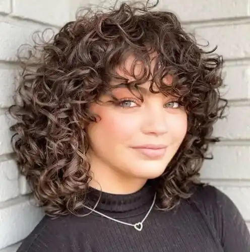 Curly hairstyles with bangs 2025